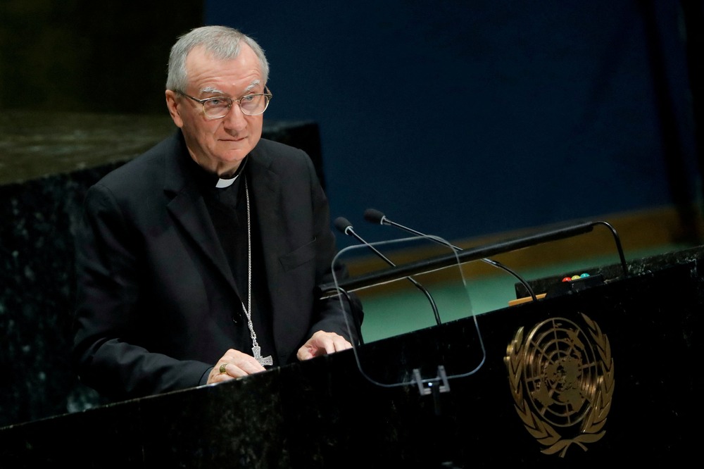 Cardinal Pietro Parolin, U.N. General Assembly, New York, NY, Sept. 28, 2018. Parolin stands at lectern, wearing plain black clerics and pectoral cross.