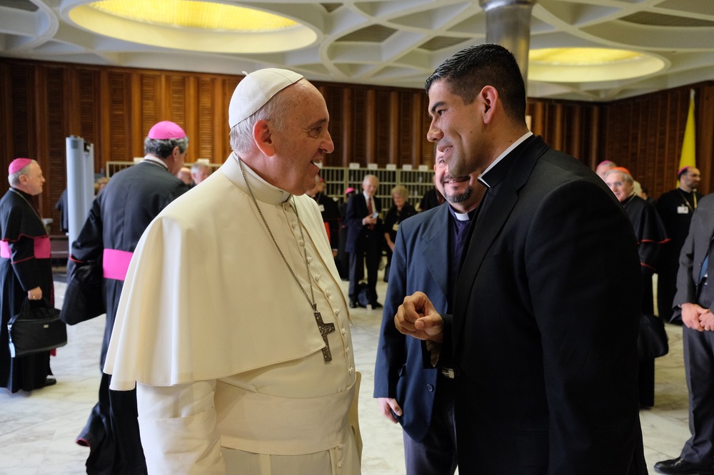 Father Manuel Dorantes, new administrative management director for the Laudato Si' Center for Higher Education. Francis and Dorantes face each other smiling in conversation.