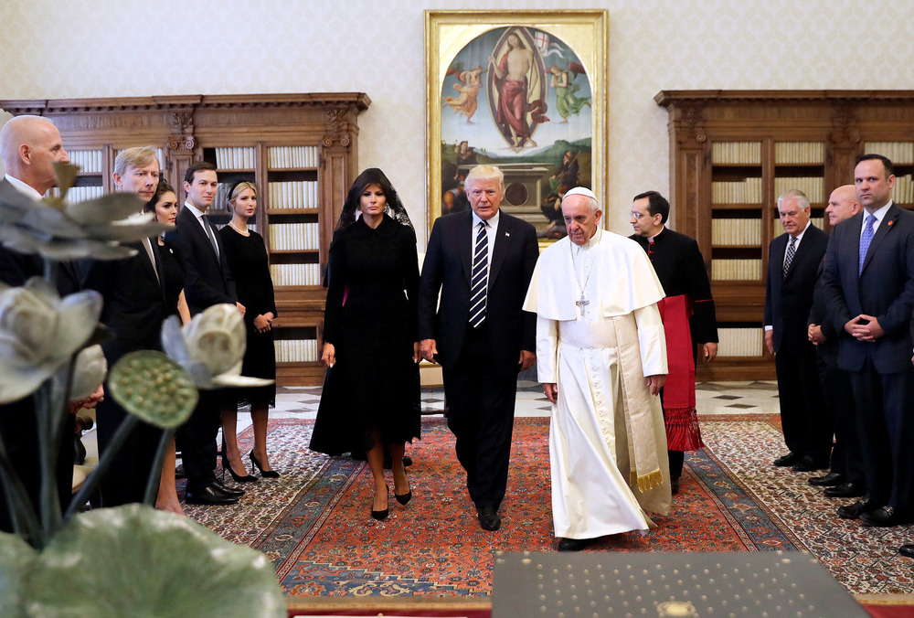 Trump and Pope Francis, 2017. Trump walks center, to his left is Pope Francis, and to his right is Melania.