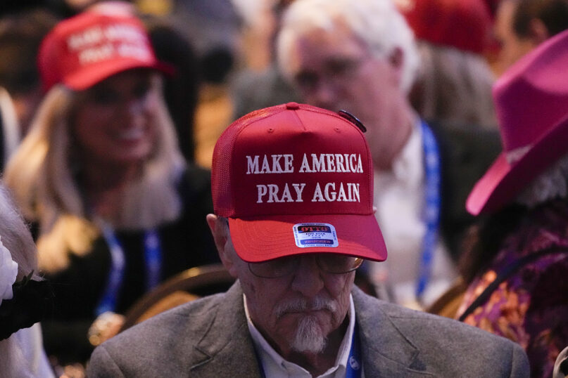 Make American Pray Again, Trump, Nashville, Tenn., Feb. 22, 2024. Man's head bowed, text of hat visible.