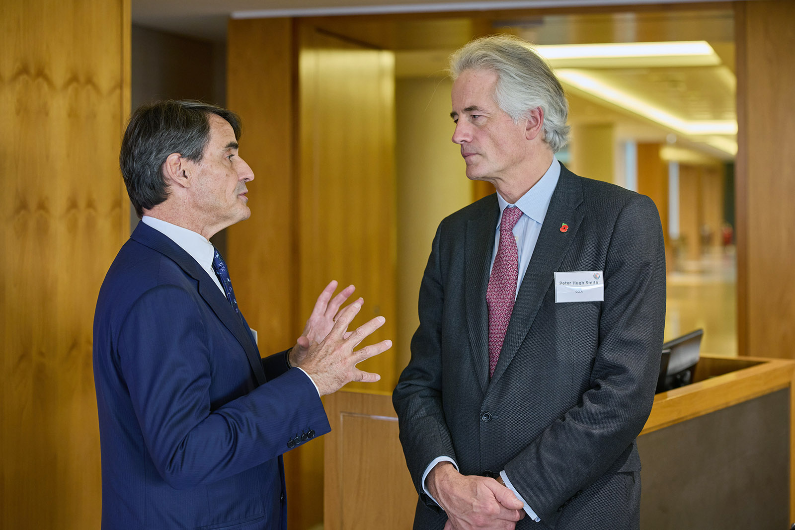 Mensuram Bonam Summit, London, Nov. 11, 2024. de Franssu and Smith face each other talking.