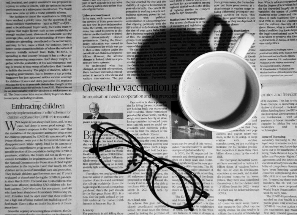 mug and eyeglasses on newspaper mug and eyeglasses on newspaper