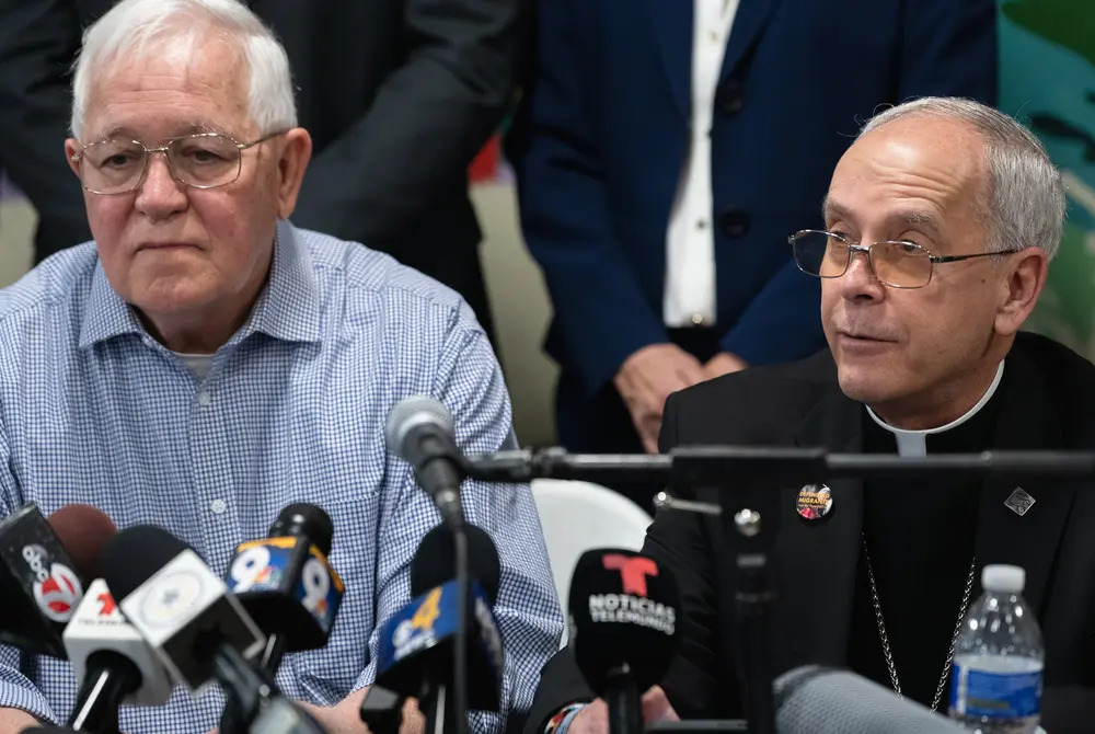 Ruben Garcia and Bishop Mark Seitz, El Paso, Feb. 23, 2024. The two men sit side by side in front of microphones, Seitz wears black clerics.
