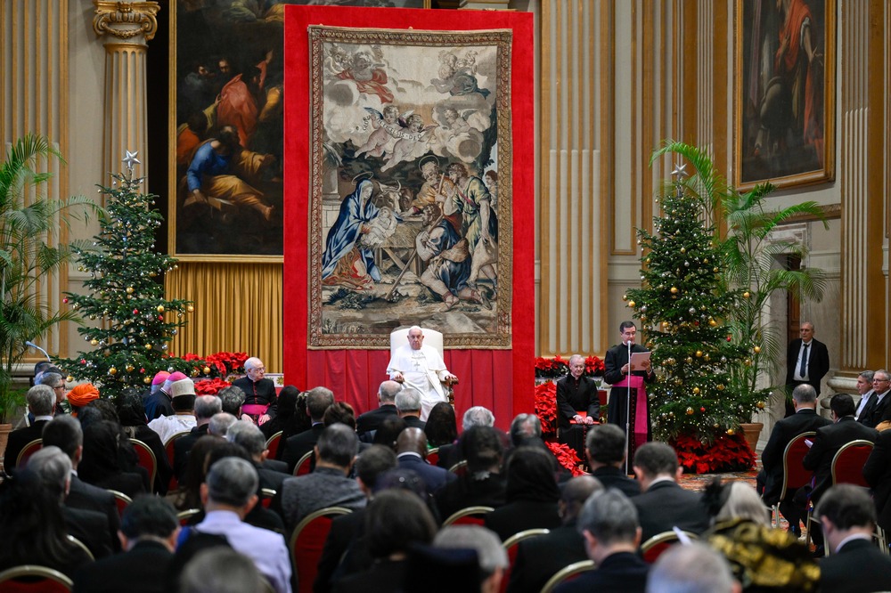 Pope Francis, diplomatic reception, Hall of Blessing, Apostolic Palace, Vatican, Jan. 9, 2025. Pope sits on raised dais in front of tapestry facing diplomats.