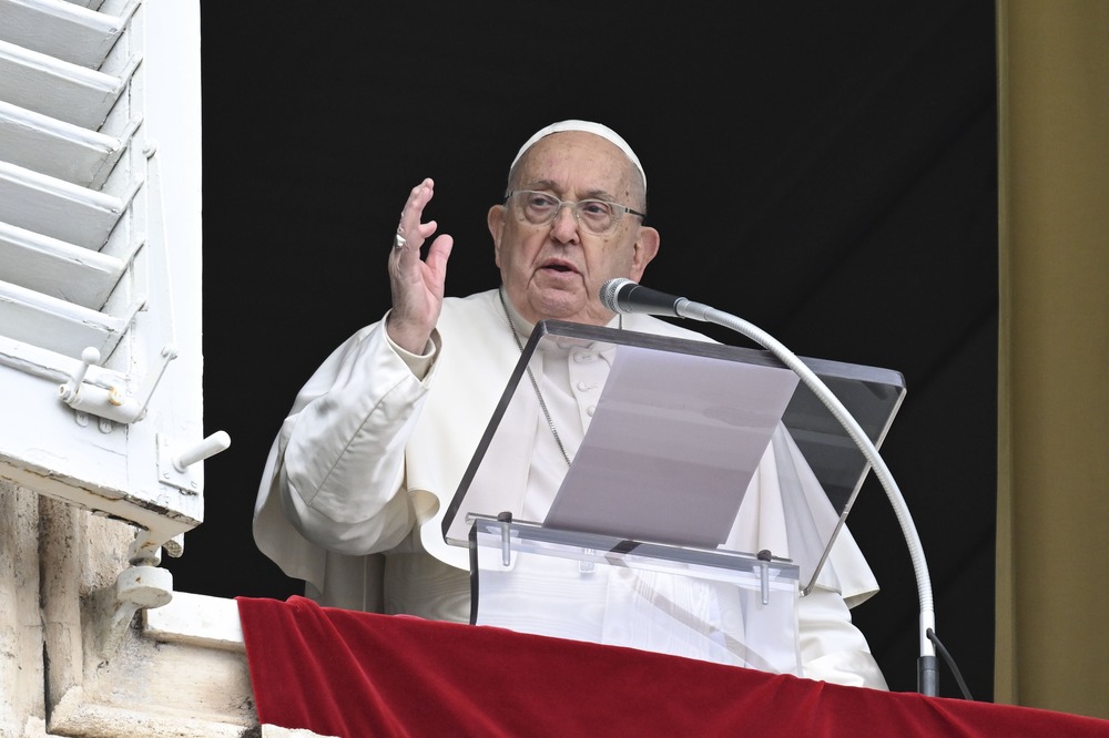 Pope Francis, Angelus, Jan. 12, 2024. Francis at window, hand raised in blessing.