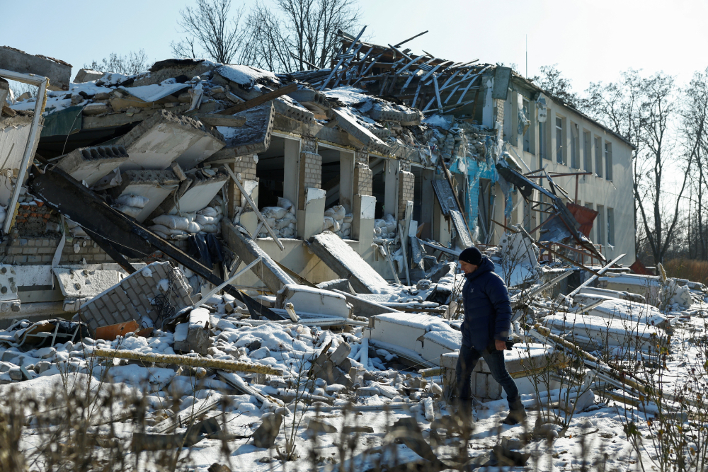 RUSSIAN AIRSTRIKE UKRAINE BUILDING on Feb. 18, 2025 Yurii Bilyk, director of a local lyceum, walks next to the organization's building in Dnipropetrovsk region, Ukraine, Feb. 18, 2025. The structure was destroyed by a recent Russian airstrike.