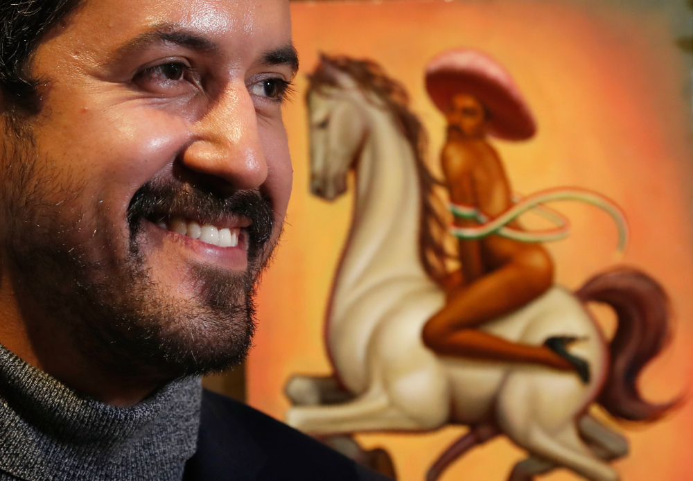 Mexican artist Fabián Cháirez Mexican artist Fabián Cháirez stands next to his painting showing Mexican Revolution hero Emiliano Zapata straddling on a horse nude, wearing high heels and a pink, broad-brimmed, during an interview at the Fine Arts Palace in Mexico City, Wednesday, Dec. 11, 2019.