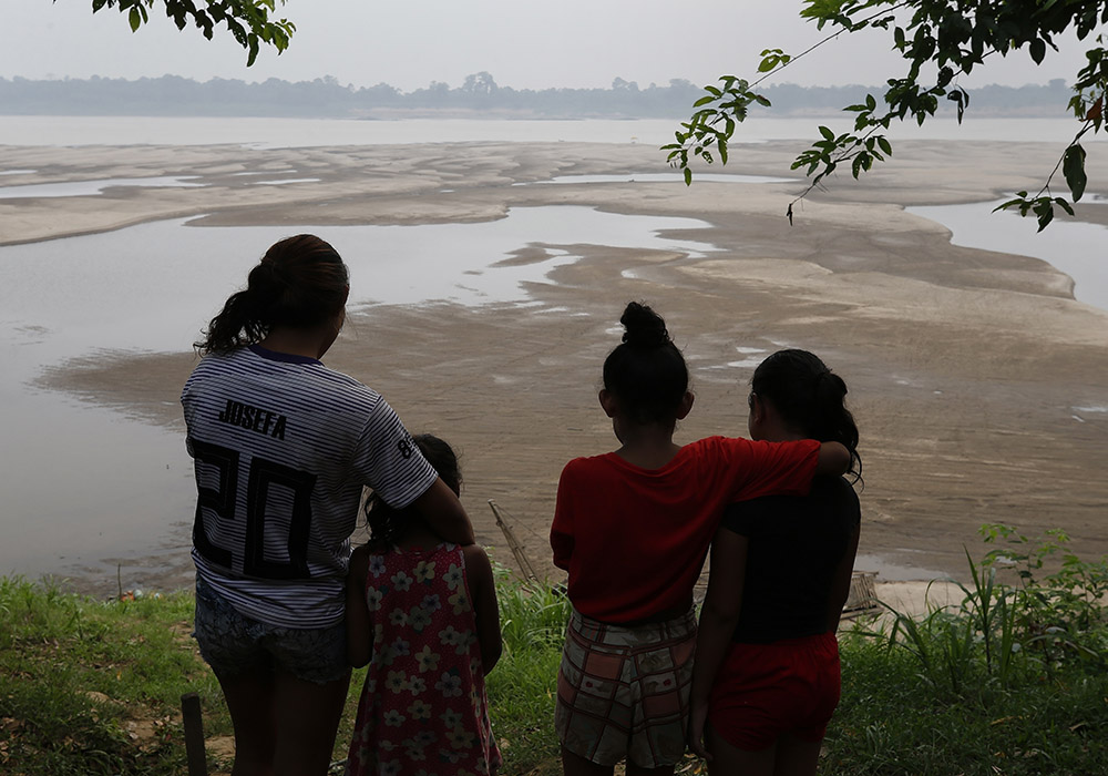 Residents look out at the Madeira River, a tributary of the Amazon River amid a drought in Humaita, Amazonas state, Brazil, Sept. 7, 2024. "Fraternity and Integral Ecology" is the theme of this year's Fraternity Campaign, a Lenten effort by the National Conference of Bishops of Brazil to collect funds for its social works and raise awareness of a pressing issue. (AP photo/Edmar Barros, File)