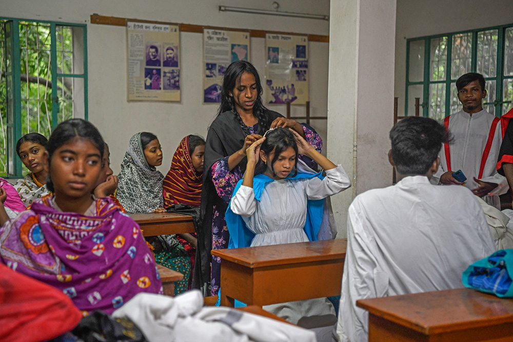 Youth participants dress in costume as they prepare for the Way of the Cross presentation inside the Dinajpur Cathedral parish building in Dinajpur, Bangladesh on Good Friday. (Piyas Biswas)