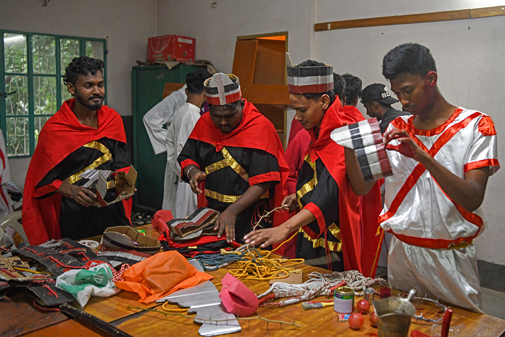 Youth participants prepare for the Way of the Cross presentation inside the Dinajpur Cathedral parish building. (Piyas Biswas)