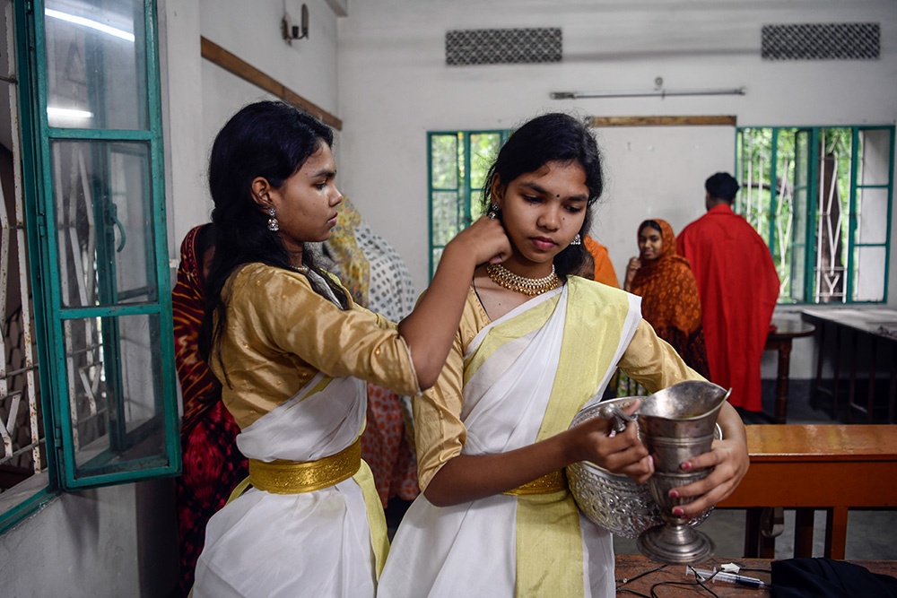 Youth participants prepare for the Way of the Cross presentation inside the Dinajpur Cathedral parish building. (Piyas Biswas)
