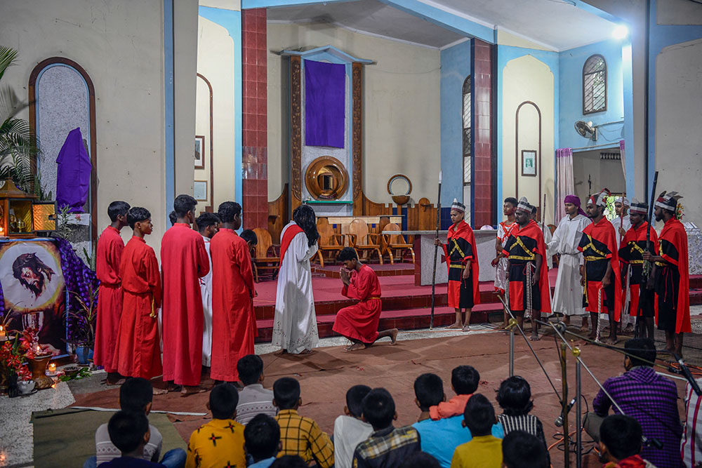Judas Iscariot betrays Jesus to his enemies during a reenactment of the Way of the Cross at Dinajpur Cathedral on Good Friday. (Piyas Biswas)
