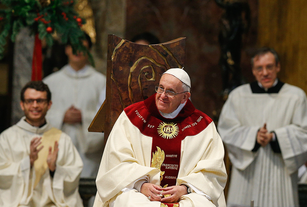 Pope Francis smiles during Mass at the Society of Jesus' Church of the Gesù in Rome Jan. 3, 2014. The pope celebrated Mass with 300 of his Jesuit confreres in thanksgiving for the canonization of Jesuit St. Peter Faber. (CNS/Paul Haring)