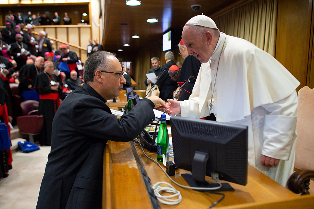 Pope Francis talks with Jesuit Fr. Antonio Spadaro during a session of the Synod of Bishops on young people, the faith and vocational discernment, at the Vatican Oct. 4, 2018. (CNS/Vatican Media)
