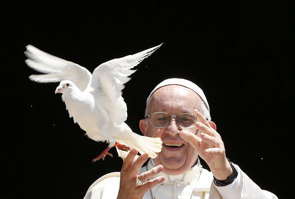 Pope Francis releases a dove as a sign of peace outside the Basilica of St. Nicholas after meeting with the leaders of Christian churches in Bari, Italy, July 7, 2018. (CNS/Paul Haring)