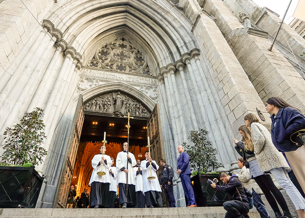 Seminarians lead a eucharistic procession from St. Patrick's Cathedral in New York City Oct. 15, 2024. A few thousand worshippers packed the cathedral for Holy Hour and Mass before participating in the procession through Midtown Manhattan. The event was a collaboration of the Napa Institute and the Hallow prayer app. (OSV News/Gregory A. Shemitz)
