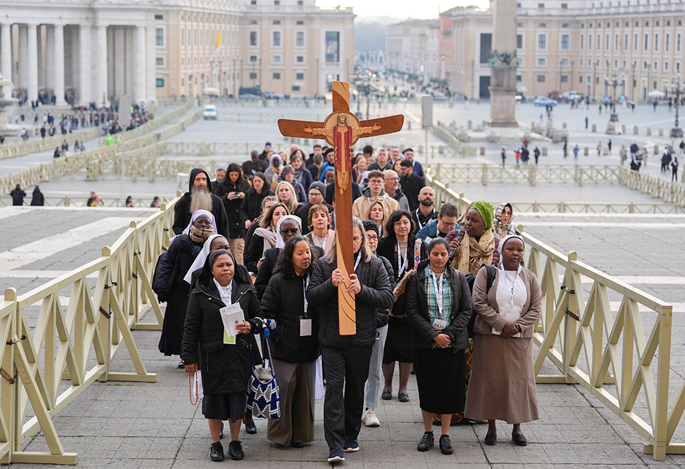 Pilgrims make their way through St. Peter's Square toward the Holy Door of St. Peter's Basilica during the Jubilee of the World of Communications at the Vatican on Jan. 25, 2025. (CNS/Lola Gomez)