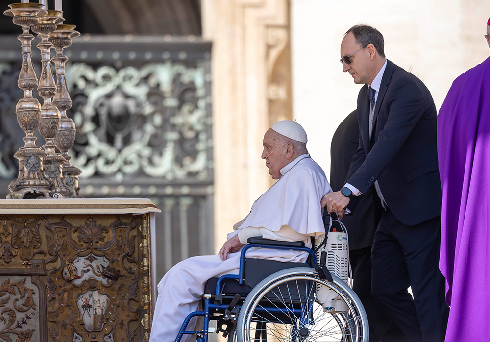Pope Francis is brought on stage in St. Peter's Square by his nurse, Massimiliano Strappetti, at the end of the closing Mass for the Jubilee of the Sick and Health Care Workers at the Vatican April 6, 2025. (CNS/Pablo Esparza)