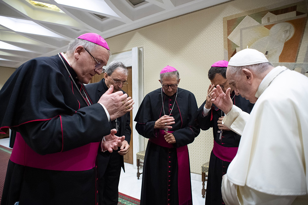 Pope Francis and four French bishops make the sign of the cross during silent prayer for the victims of abuses committed by members of the clergy, prior to the pope's general audience at the Vatican Oct. 6, 2021. (CNS/Vatican Media)