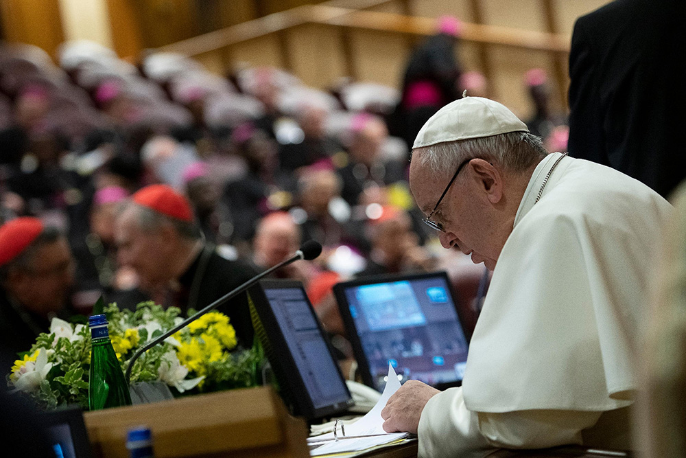 Pope Francis reviews papers Feb. 23, 2019, the third day of a meeting on the protection of minors in the church at the Vatican. (CNS/Vatican Media)