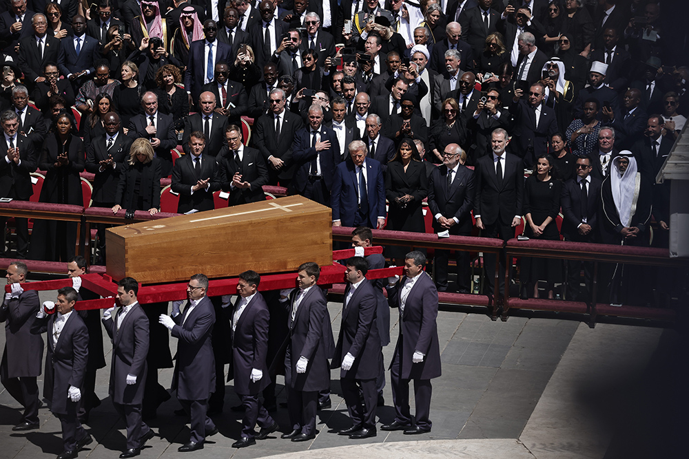 Fourteen pallbearers carry the casket of Pope Francis past world leaders, including U.S. President Donald Trump, center, at the end of the pope's funeral Mass April 26, 2025, in St. Peter's Square at the Vatican. (CNS/Pablo Esparza)