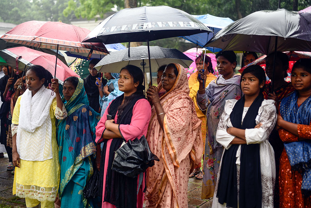 People watch the Way of the Cross reenactment outside Dinajpur Cathedral. (Piyas Biswas)