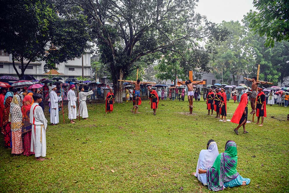 People witness Jesus' crucifixion during the Way of the Cross reenactment outside Dinajpur Cathedral. (Piyas Biswas)