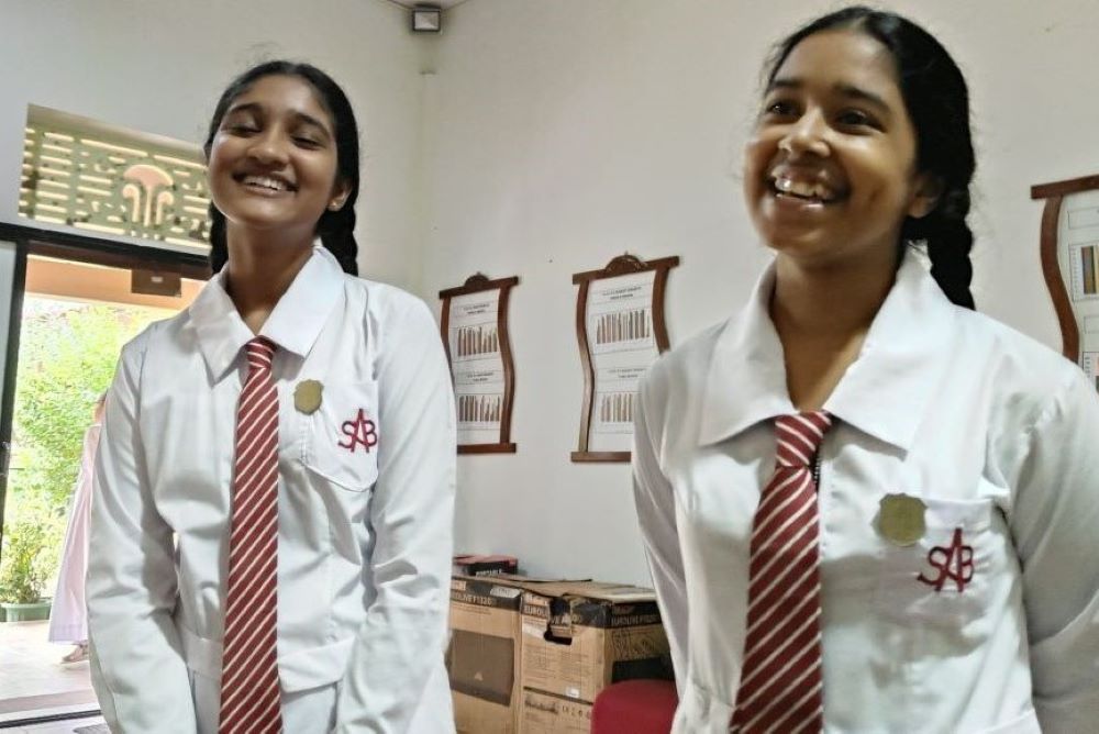 2 girls in school uniforms