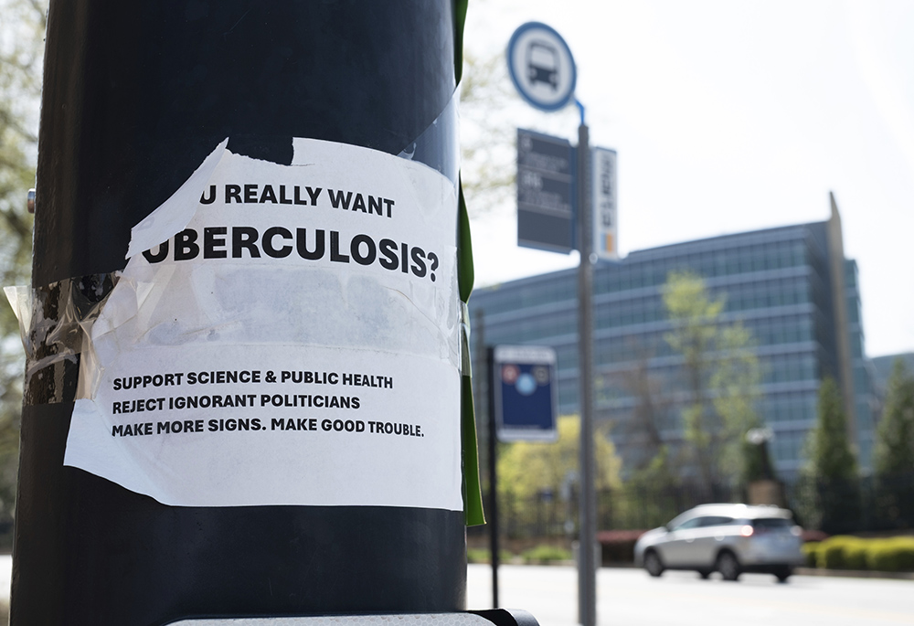 A sign about tuberculosis is pictured taped to a light pole across the street from the Centers for Disease Control and Prevention headquarters April 1 in Atlanta. (AP photo/Ben Gray)