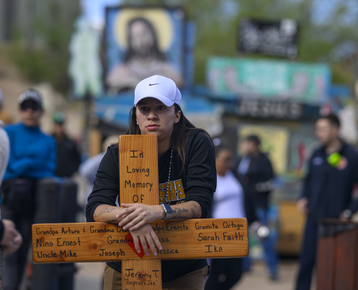 Maria Sandoval leans on a handmade cross bearing the names of loved ones passed as she waits in line to visit El Santuario De Chimayo Maria Sandoval leans on a handmade cross bearing the names of loved ones passed as she waits in line to visit El Santuario De Chimayo in Northern New Mexico on Good Friday, April 18, 2025. Chimayo, N.M. (AP Photo/Roberto E. Rosales)