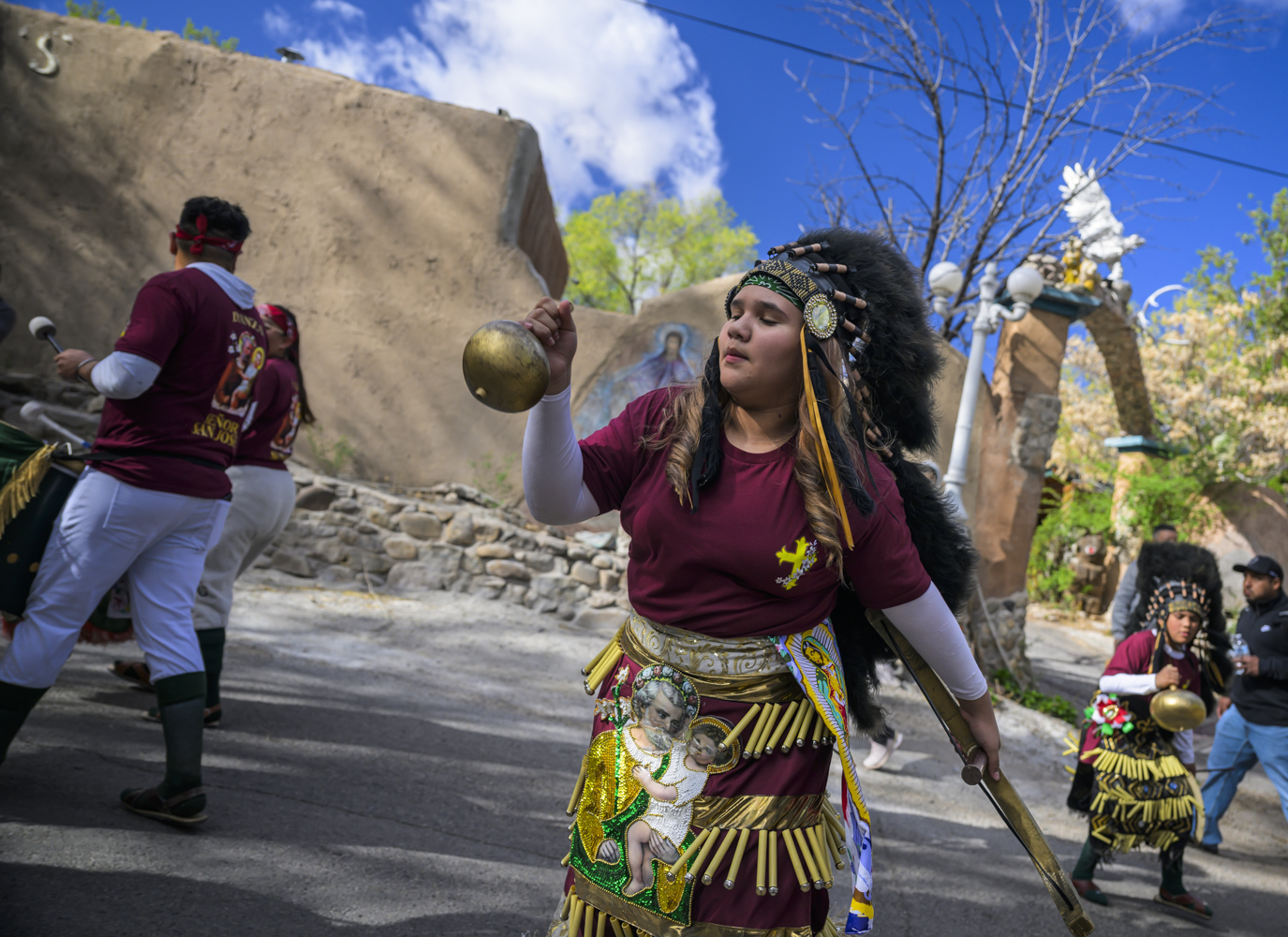 Josie Esquivel along with members of the Danza Señor San Jose dance group performs behind El Santuario De Chimayo in Northern New Mexico on Good Friday Josie Esquivel along with members of the Danza Señor San Jose dance group performs behind El Santuario De Chimayo in Northern New Mexico on Good Friday, April 18, 2025. Chimayo, N.M. (AP Photo/Roberto E. Rosales)
