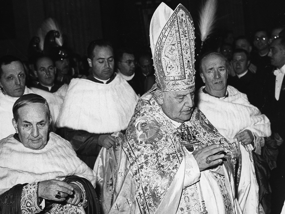 Pope John XXIII prays after his election in 1958 at the Vatican. (CNS)
