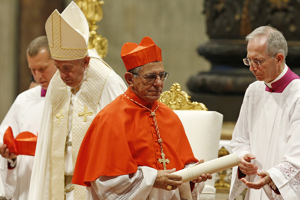 New Cardinal Juan García Rodríguez of Havana carries his scroll after receiving the red biretta from Pope Francis during a consistory for the creation of 13 new cardinals in St. Peter's Basilica at the Vatican Oct. 5, 2019. (CNS/Paul Haring)