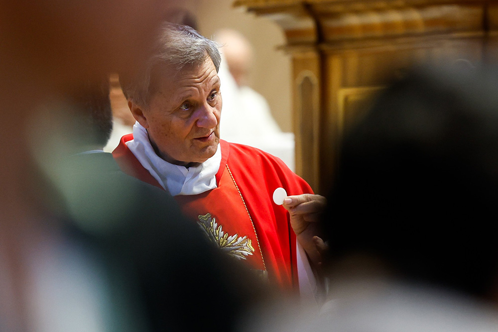 Cardinal Mario Grech distributes Communion during Mass with synod participants at the Altar of the Chair in St. Peter’s Basilica at the Vatican Oct. 21, 2024. (CNS/Lola Gomez)
