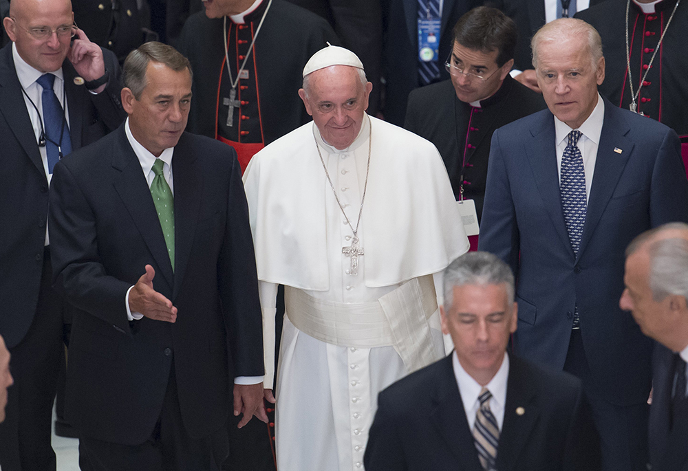 Pope Francis walks down the aisle with then-U.S. Speaker of the House John Boehner and then-Vice President Joe Biden after delivering an address to a joint session of Congress at the U.S. Capitol in Washington Sept. 24, 2015. Biden attended the April 26, 2025, funeral of Francis, who died April 21 at age 88.(OSV News/Michael Reynolds, pool via Reuters)
