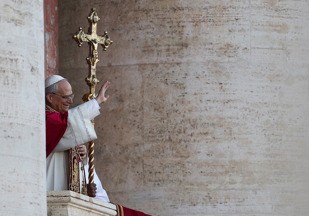 Cardinal Robert Francis Prevost, who has chosen the papal name Leo XIV, waves to the crowd on the central balcony of St. Peter's Basilica at the Vatican May 8, 2025, following his election during the conclave. He is the first American pope in history. (OSV News/Reuters/Stoyan Nenov)