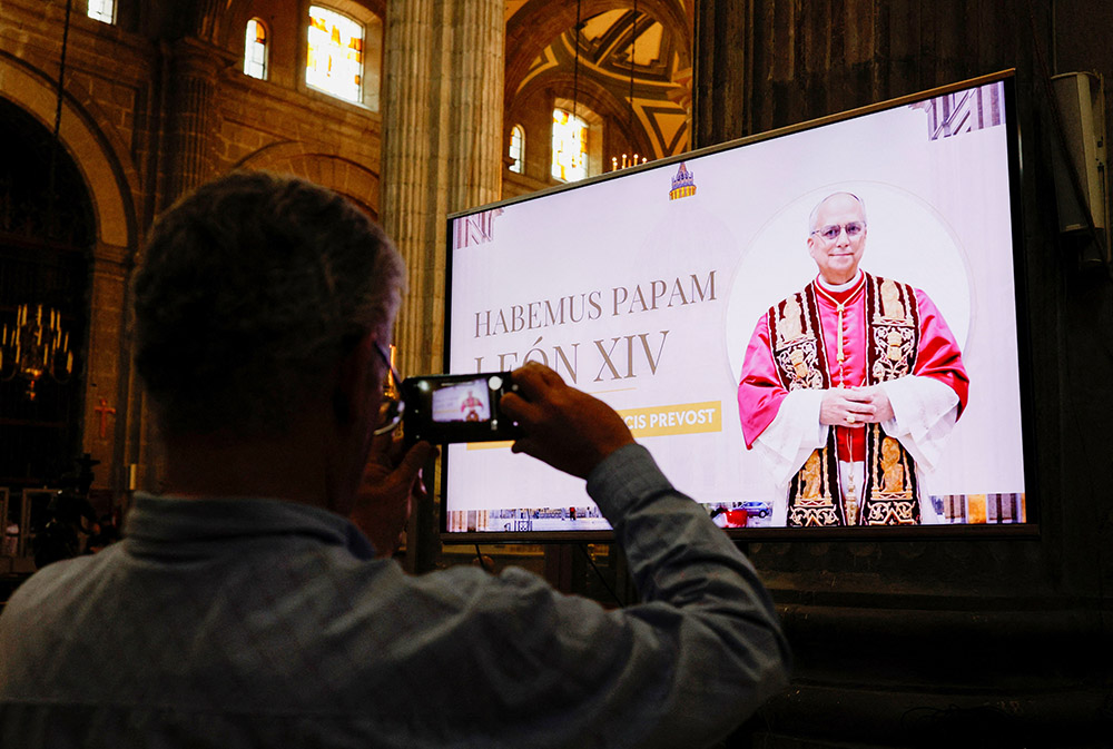A member of the faithful holds their phone after Mass at the Metropolitan Cathedral in Mexico City, where an image of the pope was shown on screen at Zocalo Square May 8, 2025, after Cardinal Robert Prevost was announced as Pope Leo XIV. (OSV/Reuters/Henry Romero)