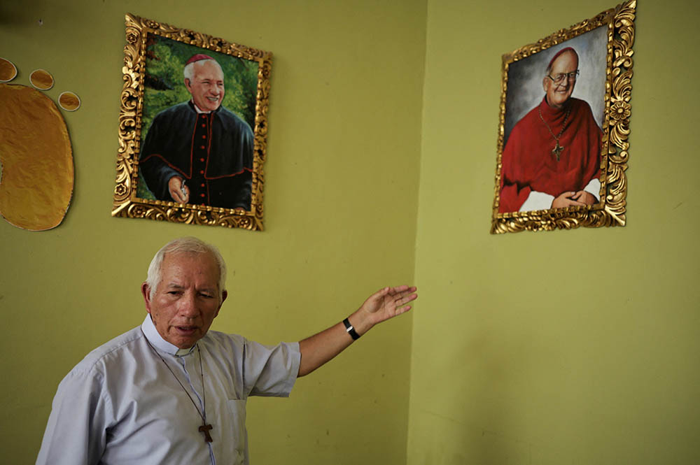 Bishop Cristóbal Bernardo Mejía Corral of Chulucanas, Peru, shows images on the wall at the dining room of the house in Chulucanas, May 11, 2025, where then-Fr. Robert Prevost, now Pope Leo XIV, stayed as a young missionary. (OSV News/Reuters/Sebastian Castaneda)