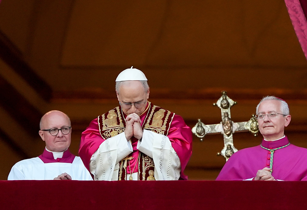 Pope Leo XIV, the former Cardinal Robert F. Prevost, prays as he stands on the central balcony of St. Peter’s Basilica at the Vatican after his election as pope May 8, 2025. The new pope was born in Chicago. (CNS/Lola Gomez)