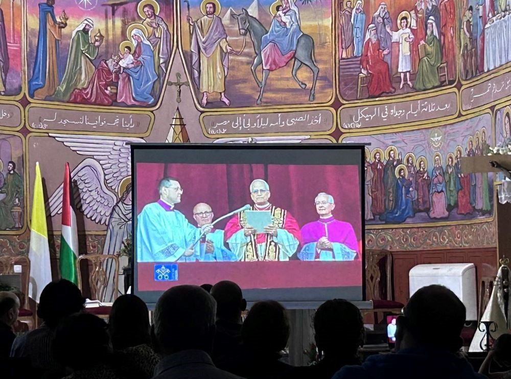 Catholics in Holy Family Parish in Gaza City watch the first appearance of Pope Leo XIV on a large screen. Catholics in Holy Family Parish in Gaza City watch the first appearance of Pope Leo XIV on a large screen.