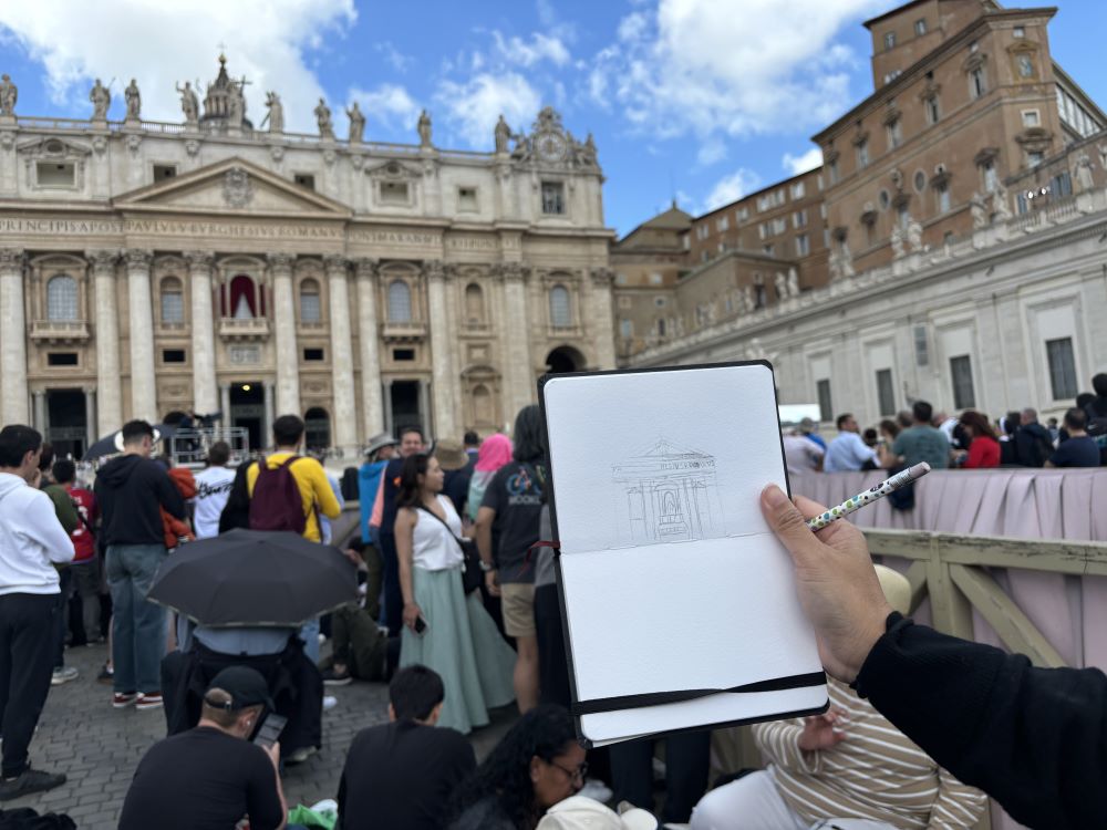 A young woman who stood alone among scattered crowds at St. Peter’s Square sketched St. Peter's Basilica 10 minutes before black smoke poured out of the chimney May 8. (NCR photo/Olivia Bardo) A young woman who stood alone among scattered crowds at St. Peter’s Square sketched St. Peter's Basilica 10 minutes before black smoke poured out of the chimney May 8. (NCR photo/Olivia Bardo)