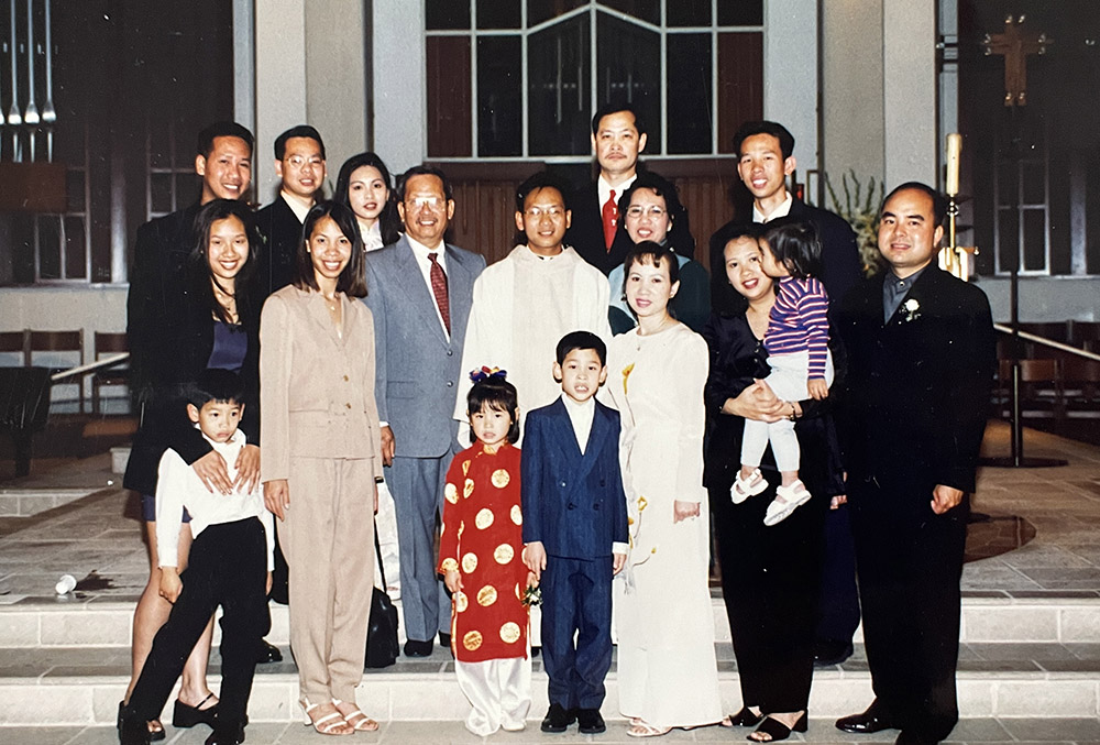Then-Fr. Michael Pham (center) poses for a photo with his family at his ordination June 25, 1999. (Courtesy of San Diego Diocese)