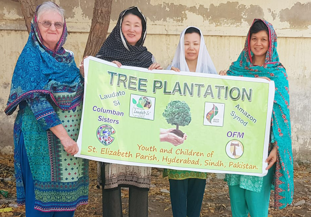 From left: Srs. Rebecca Conlon, Yoonmi Kim, Ha-suk Shin, and Anne Carbon, Columban Sisters from Latifabad, Hyderabad, in Pakistan, participate in a demonstration on Nov. 6, 2019, advocating for greening initiatives in Hyderabad following the 2019 Amazon synod. (Jawed Munawar)