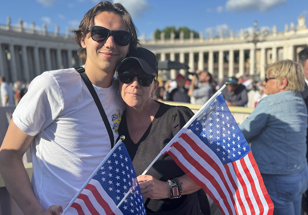 Brennan Hewitt and his mom Kathy Hewitt, Catholics from Philadelphia, hold U.S. flags in St. Peter's Square May 8 at the Vatican. (NCR photo/Rhina Guidos)
