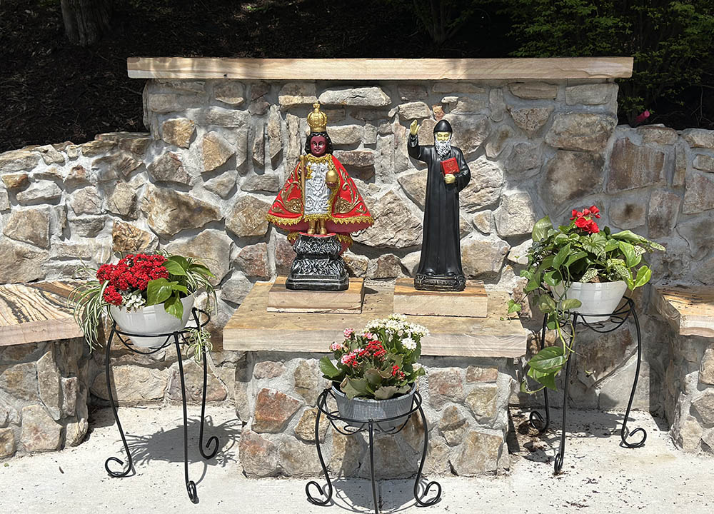 A new grotto at Mother of Good Counsel Catholic Church in Hazard, Kentucky, incorporates native plants alongside statues of St. Nino and St. Charbel, a reflection of its parishioners from the Philippines and Lebanon, respectively. (Lori Helfrich)