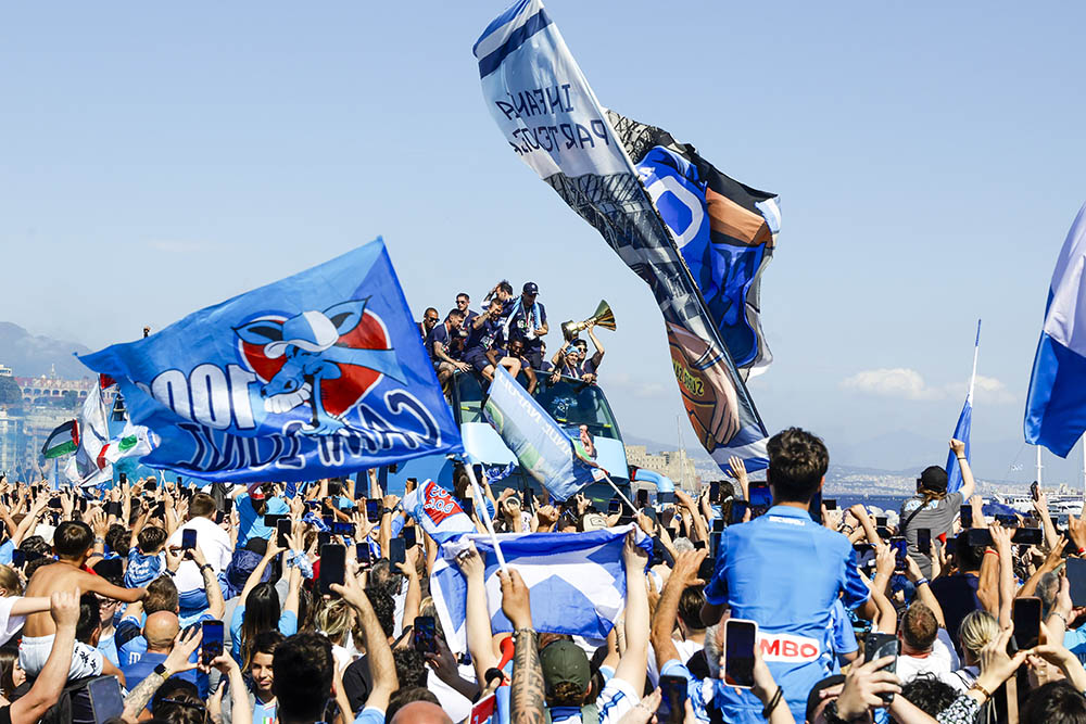 The crowd cheers as Napoli players celebrate winning their fourth Serie A soccer league title in an open-air bus parade alongside Naples' seafront, Italy on May 26, 2025. (Antonio Balasco/LaPresse via AP)