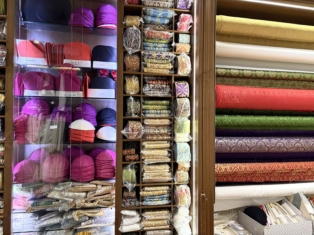 Fabrics and zucchetti for bishops and cardinals are displayed in Raniero Mancinelli's store in Rome. (Camillo Barone)