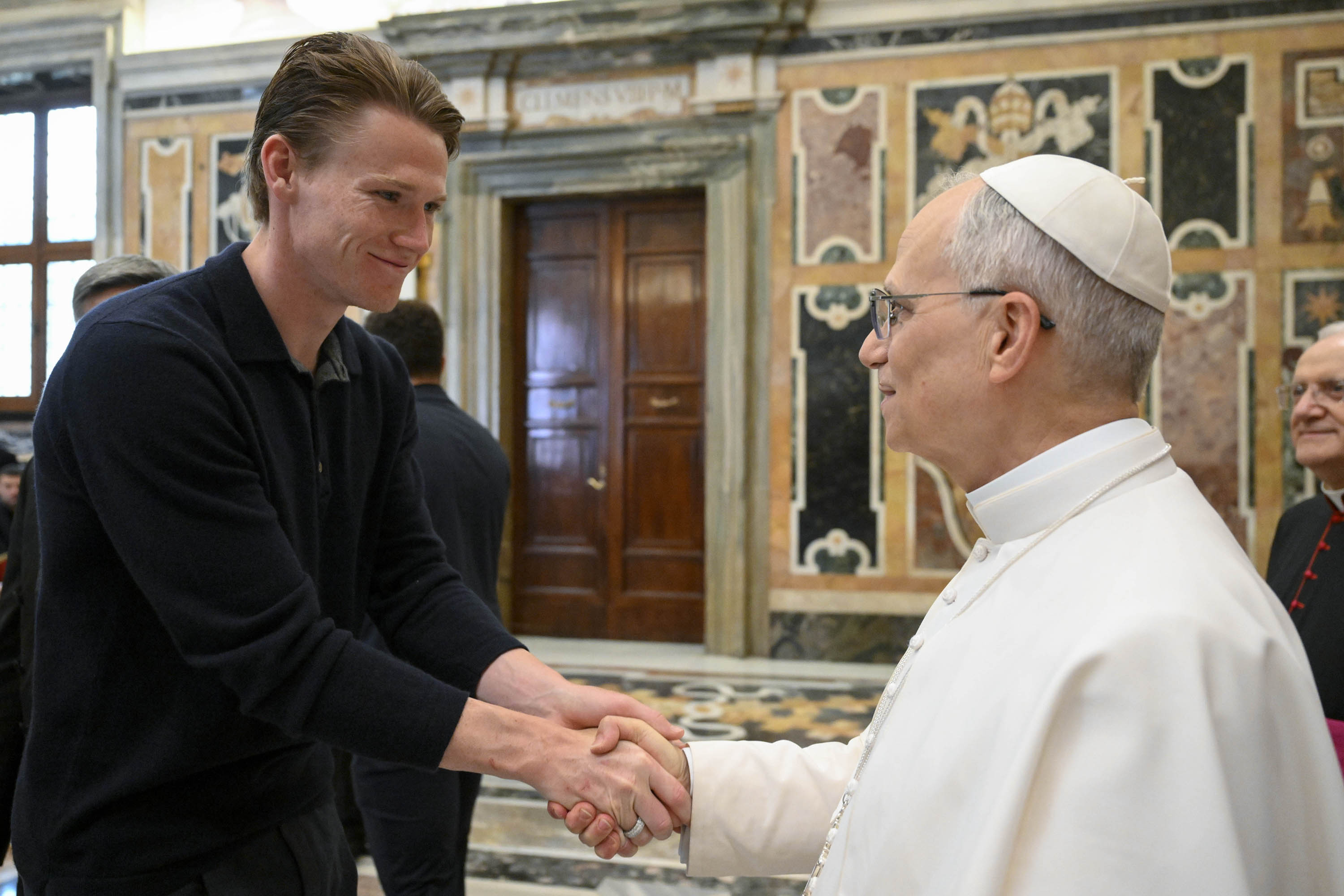 Napoli soccer team's midfielder Scott McTominay, left, shakes hands with Pope Leo XIV during a papal private audience with the team in the Clementine Hall at the Vatican on May 27, 2025. (Vadican Media via AP)