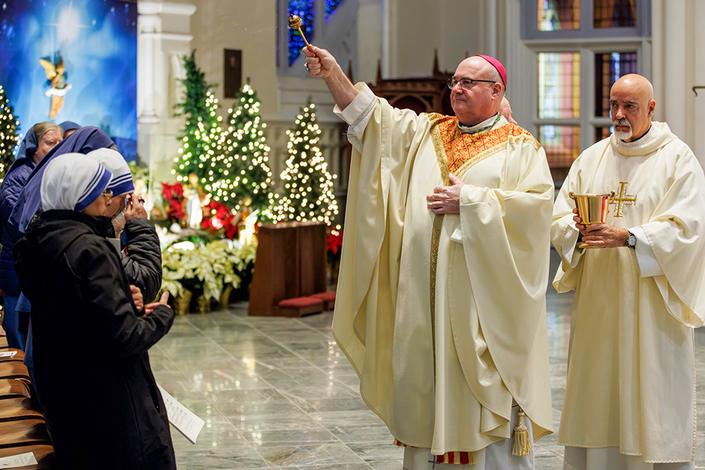 Boston Archbishop Richard Henning blesses the congregation with holy water during the Mass to open the Jubilee Year in the Boston Archdiocese, at the Cathedral of the Holy Cross in Boston, Dec. 29, 2024. (OSV News/The Pilot/Gregory L. Tracy)