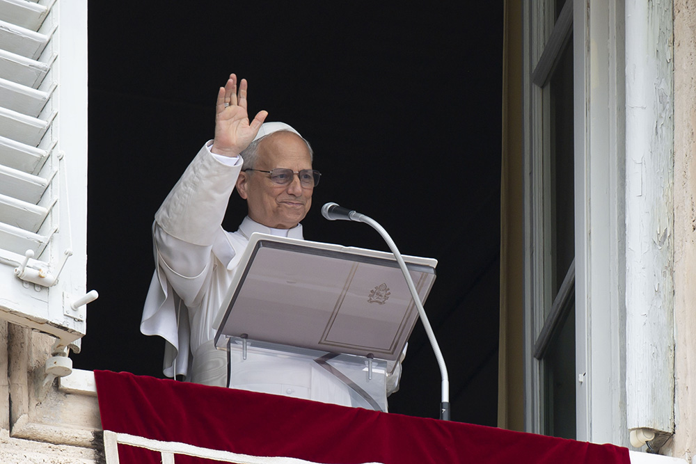 Pope Leo XIV waves to the crowd in St. Peter's Square at the Vatican as they join him for the recitation of the Angelus prayer and an appeal for peace hours after the U.S. bombed nuclear enrichment facilities in Iran June 22, 2025. (CNS/Vatican Media)